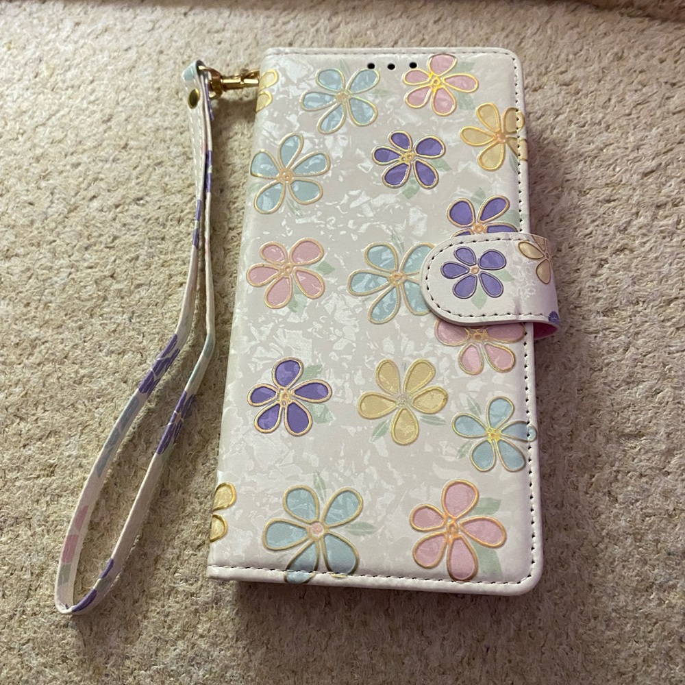 IPhone 11 phone case with carry strap and holds 2 credit cards and ID card.
